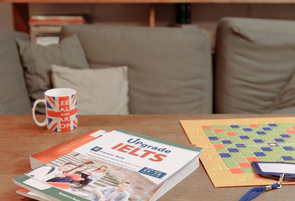 IELTS prep materials on a coffee table with a British flag mug and decor. Ideal for education themes.
